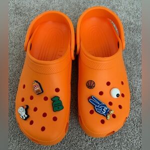 Adults Orange Crocs with Fun Jibbitz M10 W12. Never worn